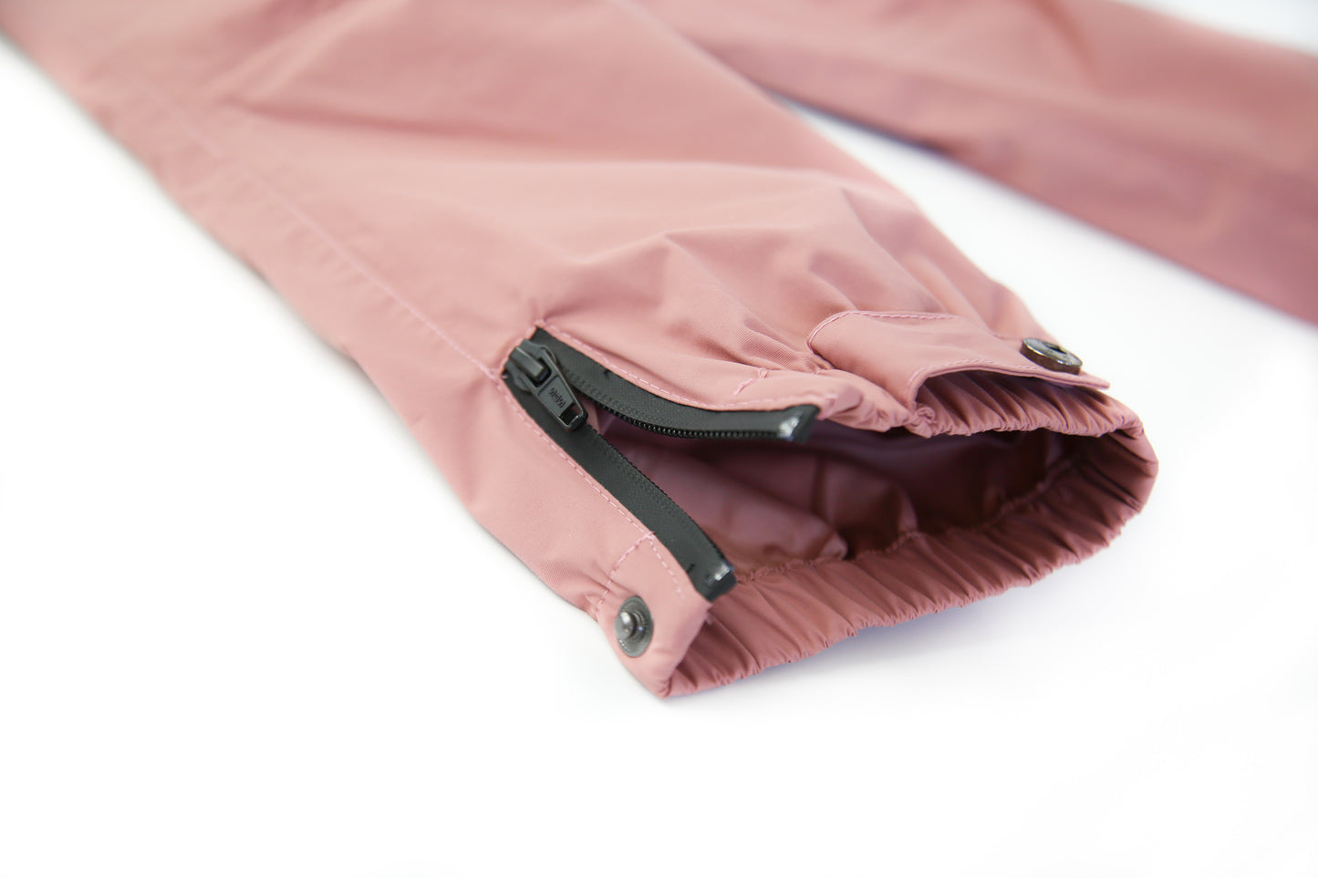 Close-up of waterproof breathable fabric – ash-rose rain pants