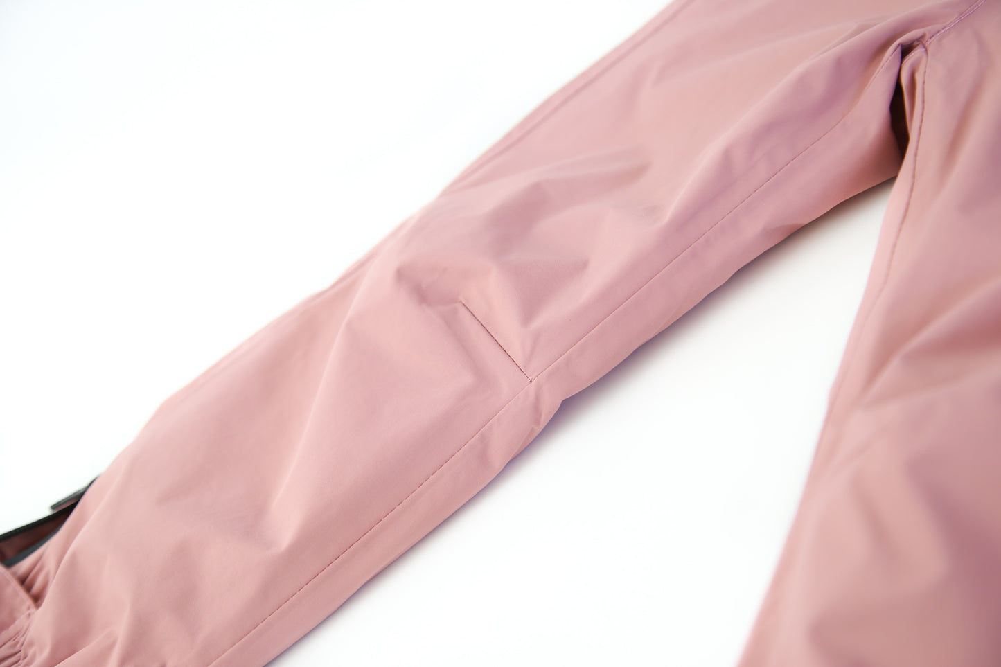 Close-up of waterproof breathable fabric – ash-rose rain pants