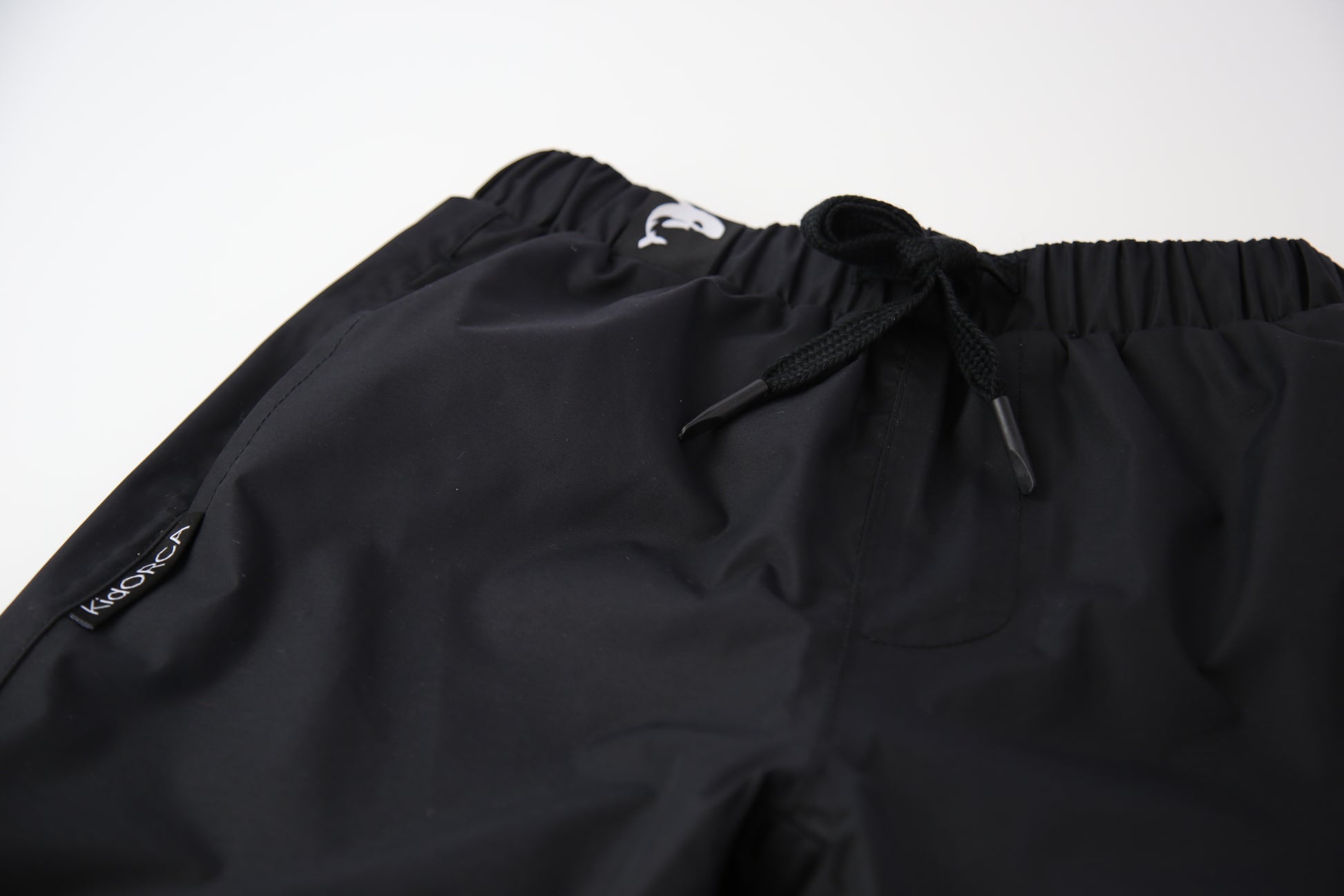 Kids black insulated waterproof rain pants – front view