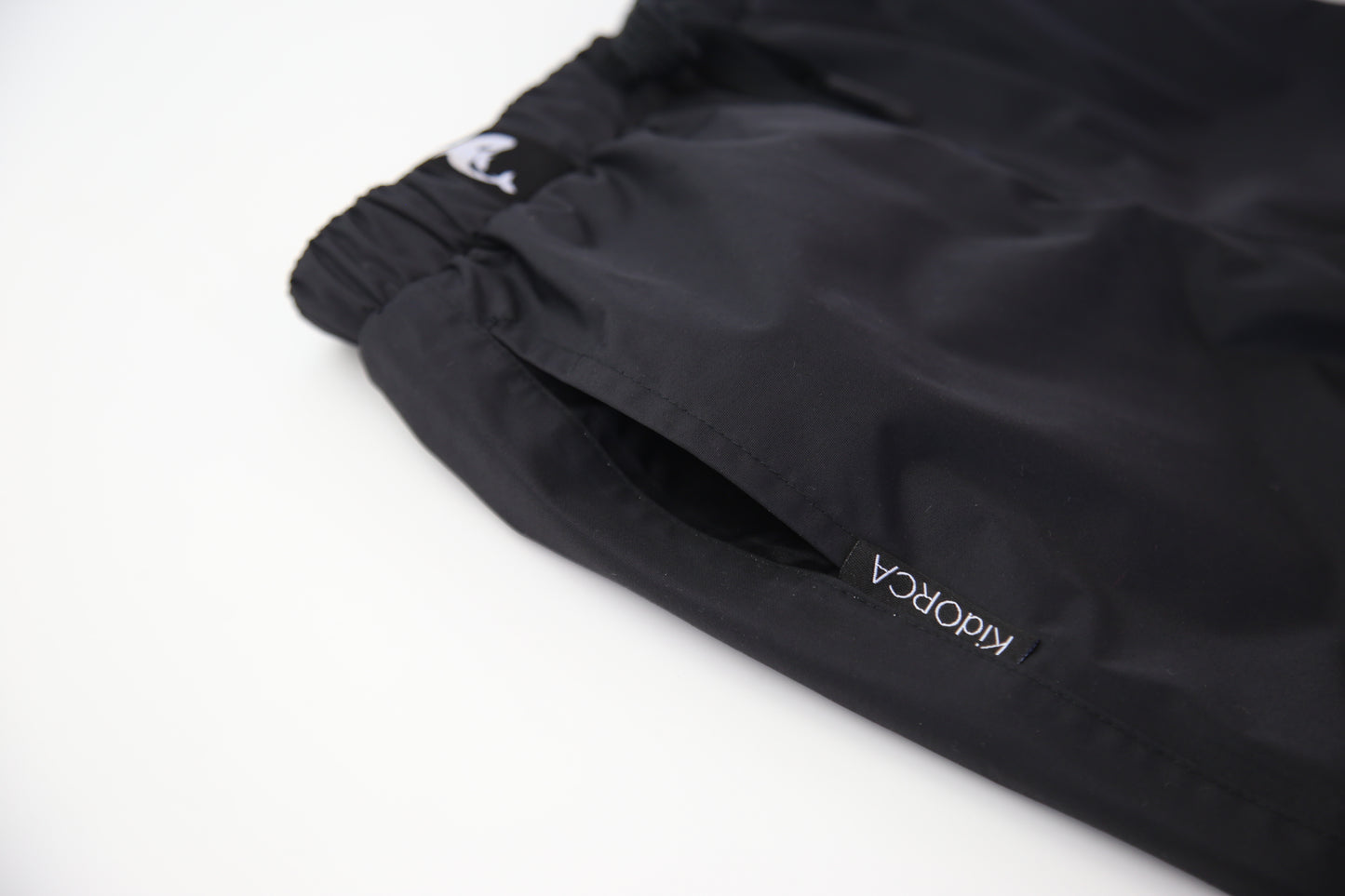 Kids black insulated waterproof rain pants – front view