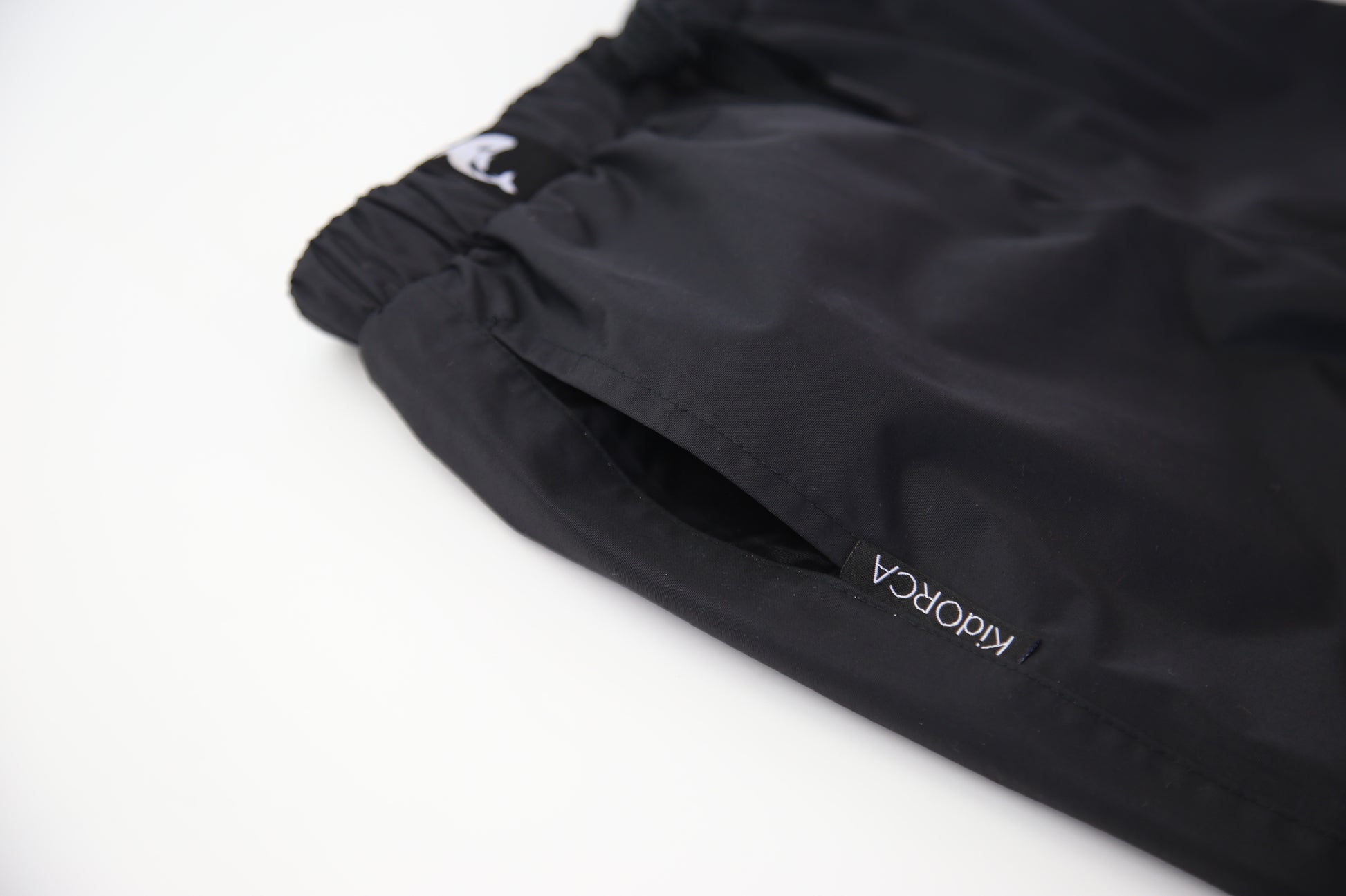 Kids black insulated waterproof rain pants – front view