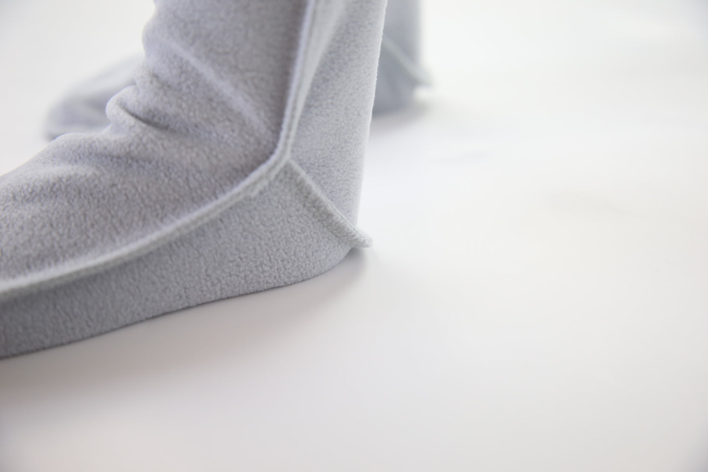 Child wearing grey fleece socks – cozy home comfort