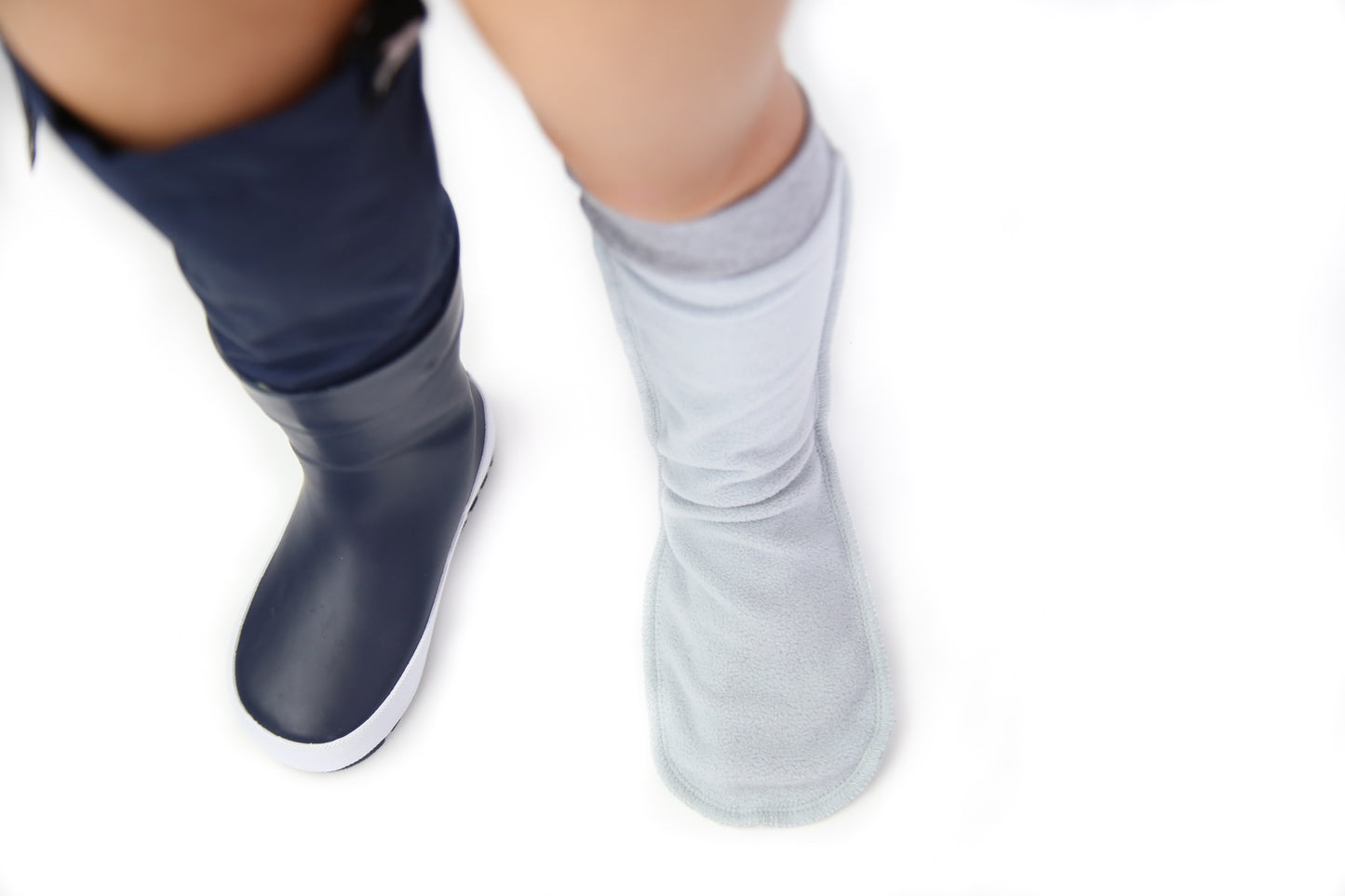 Child wearing grey fleece socks – cozy home comfort