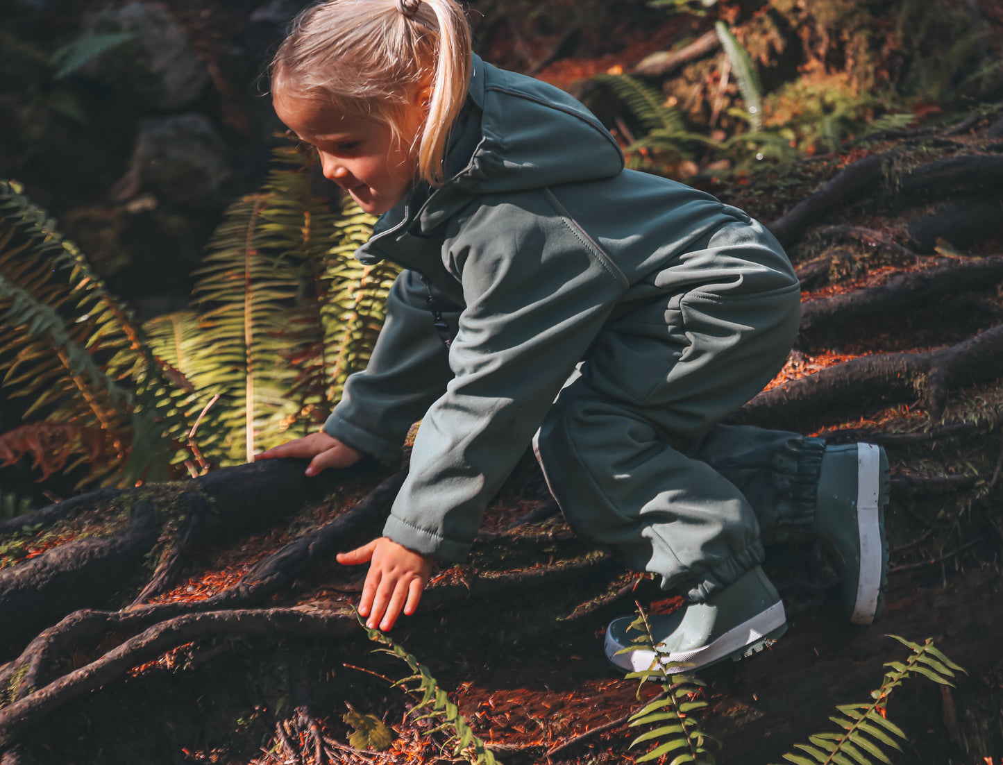 Child wearing olive play suit by KidORCA
