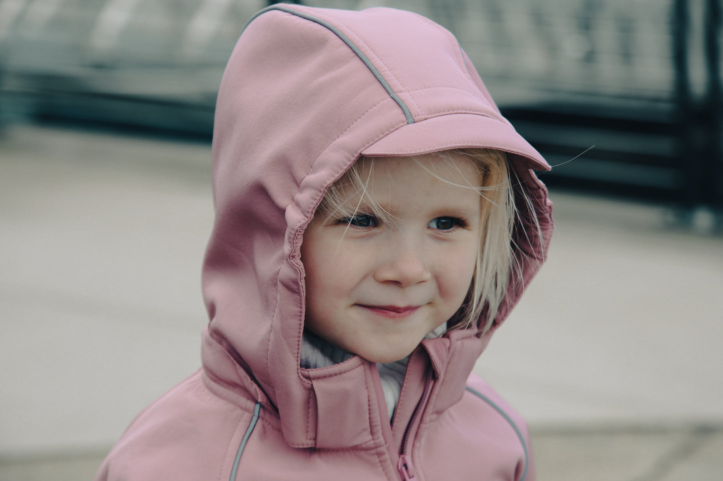 Child wearing ash-rose softshell overall by KidORCA
