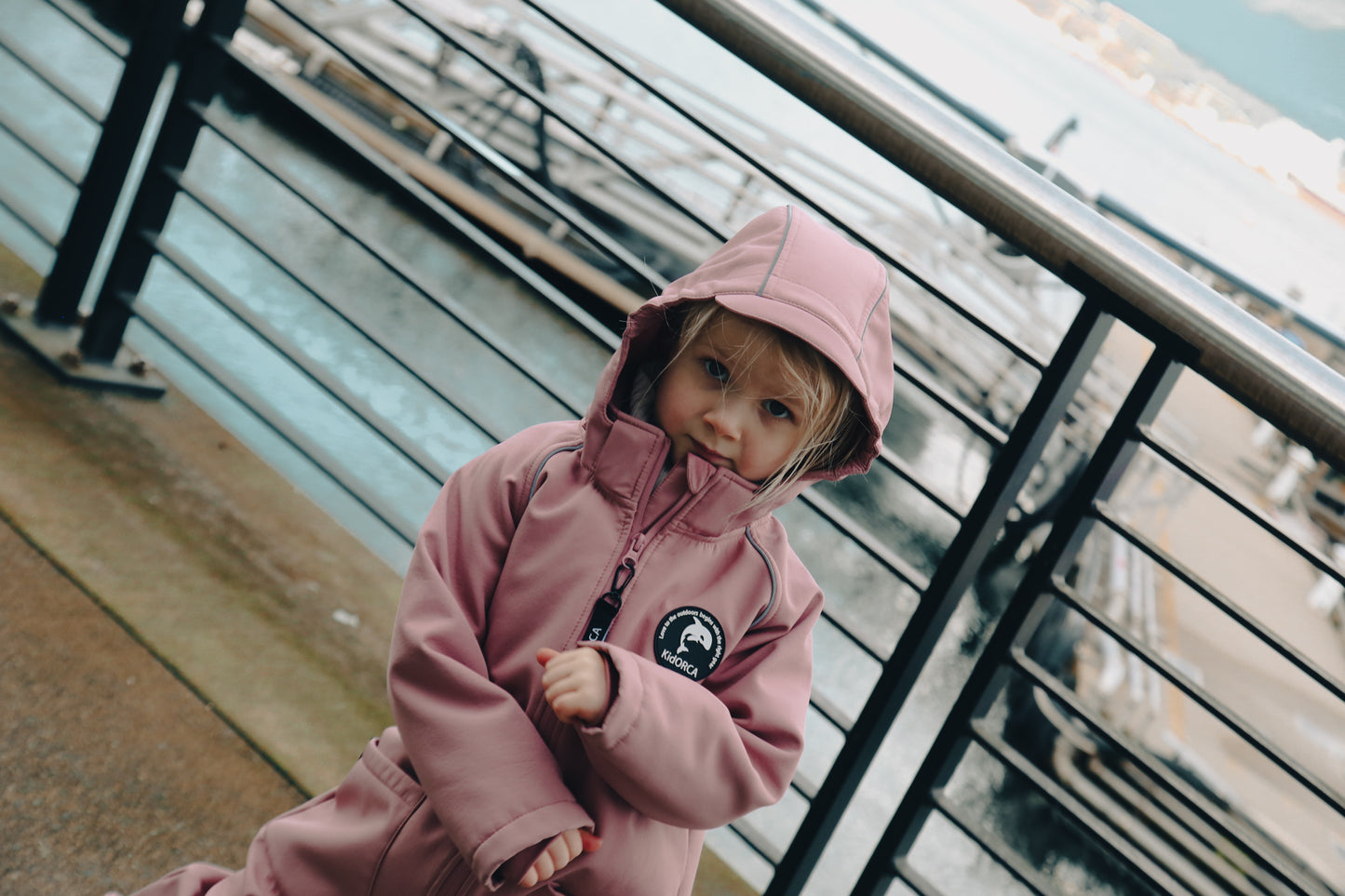 Child wearing ash-rose softshell overall by KidORCA