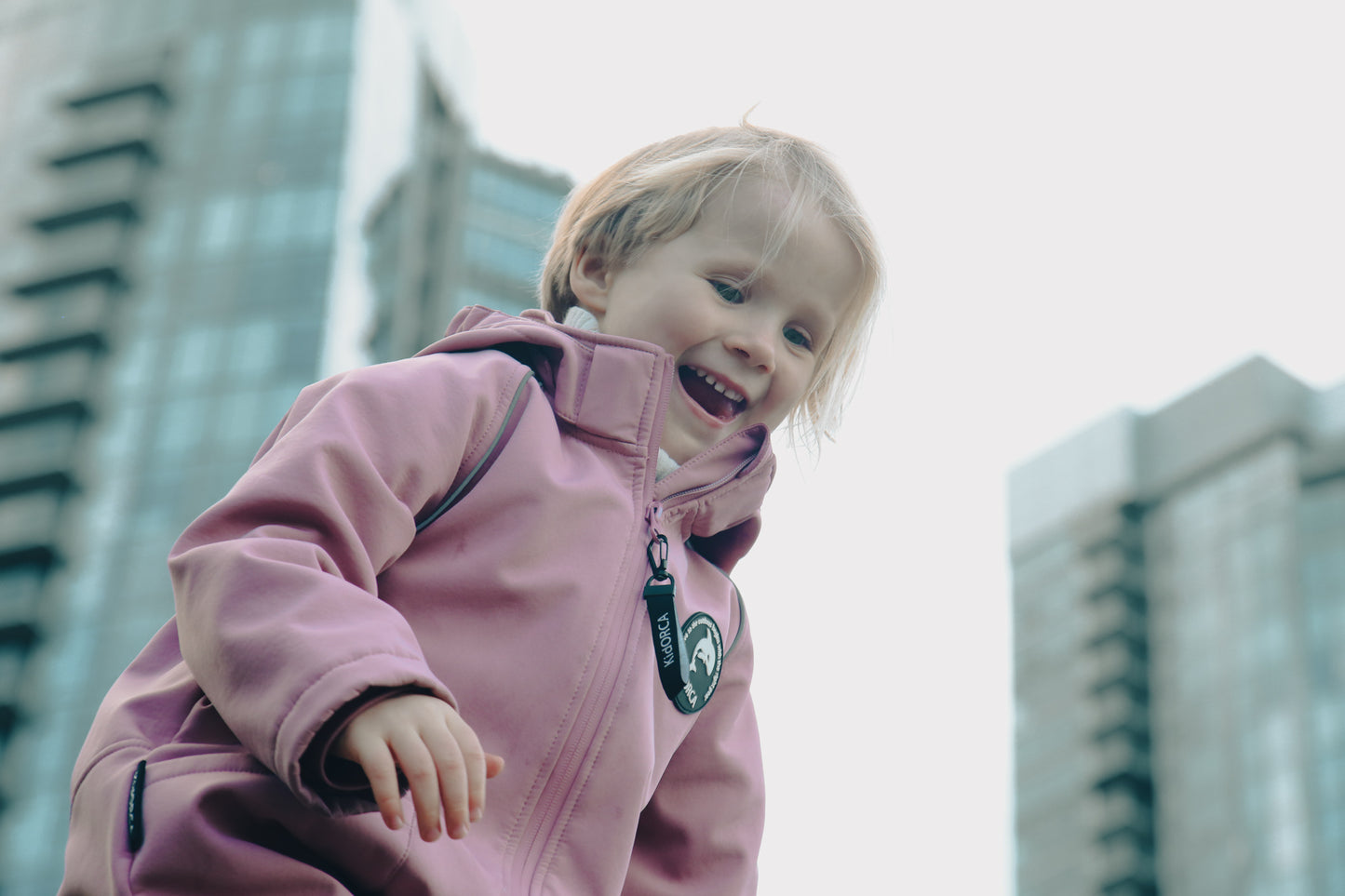 Child wearing ash-rose softshell overall by KidORCA