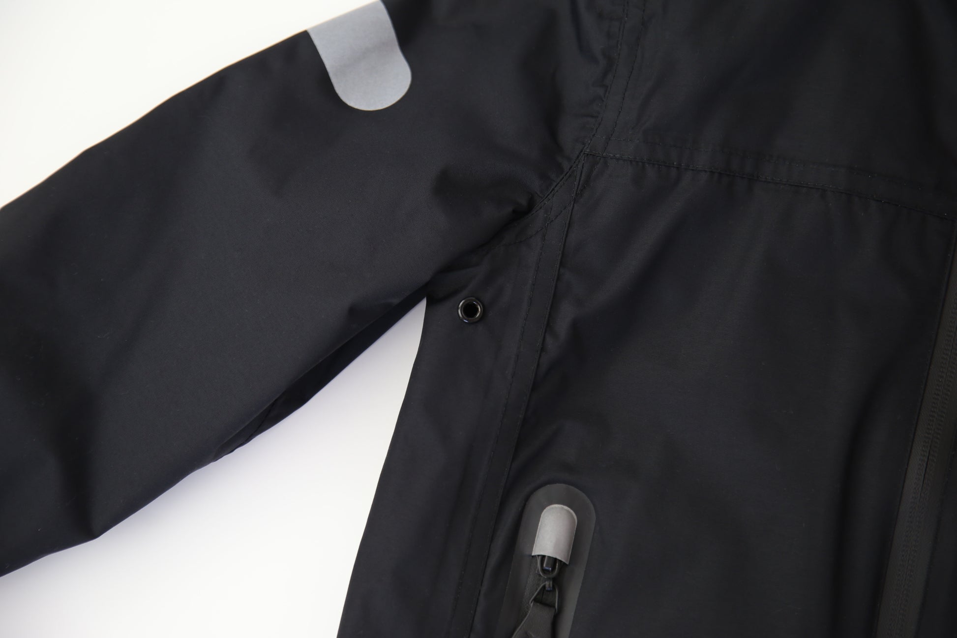 Taped seams and waterproof zipper detail – black insulated jacket