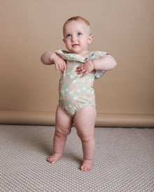 Girl playing in sage green ruffle swimsuit by KidORCA