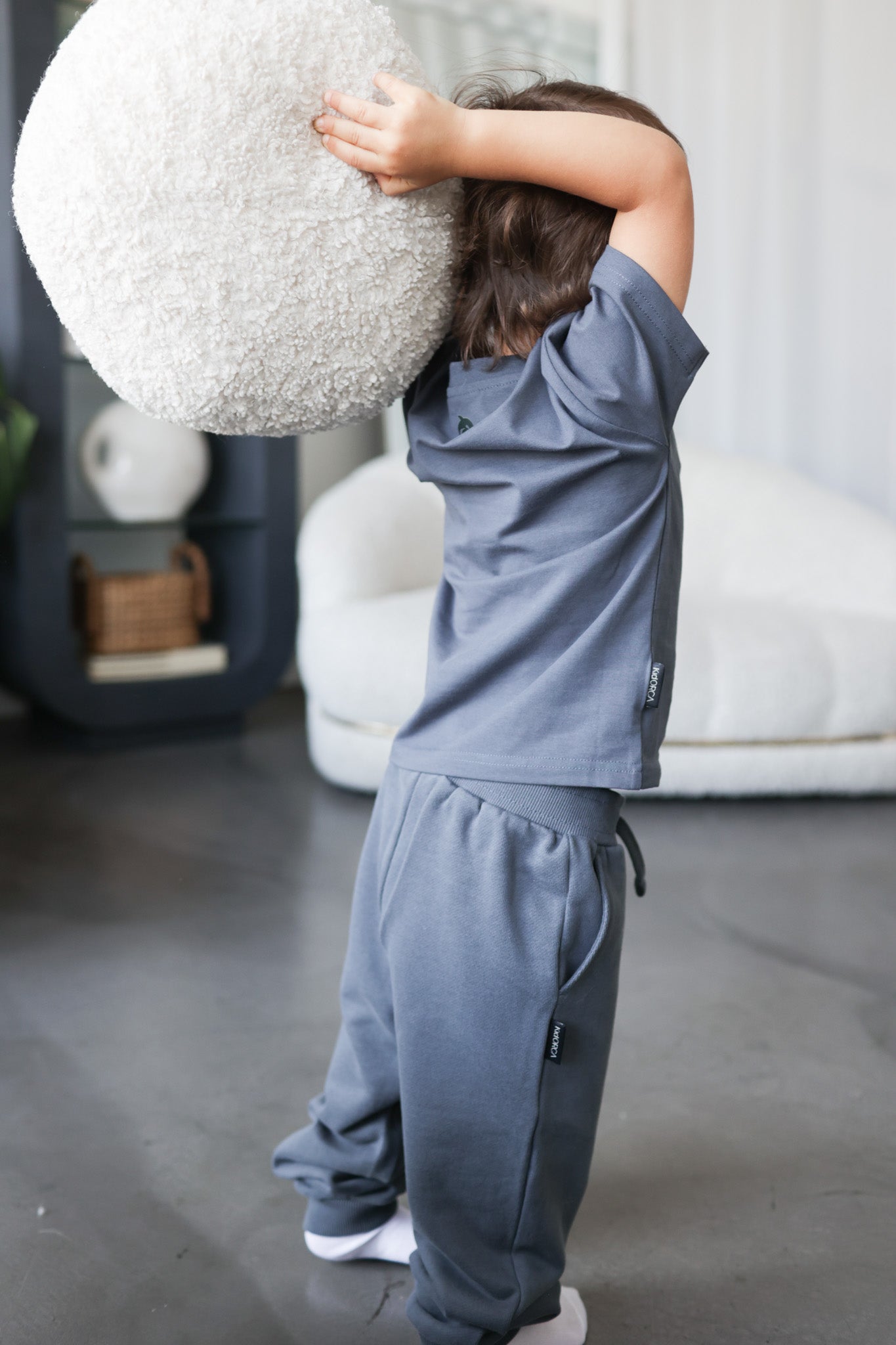 Kid playing in fjord blue organic cotton tee by KidORCA