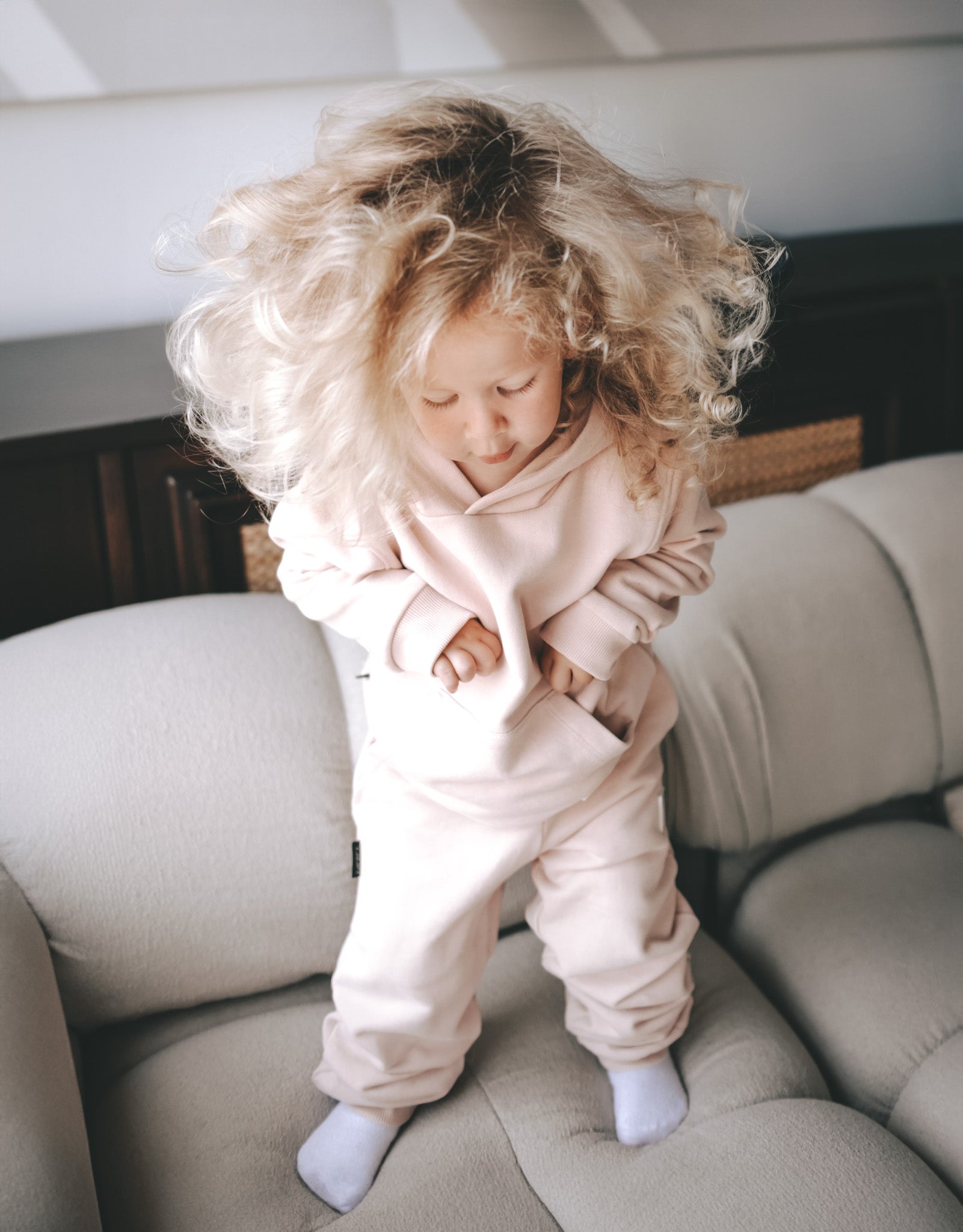 Kid playing in pale rose french terry hoodie by KidORCA
