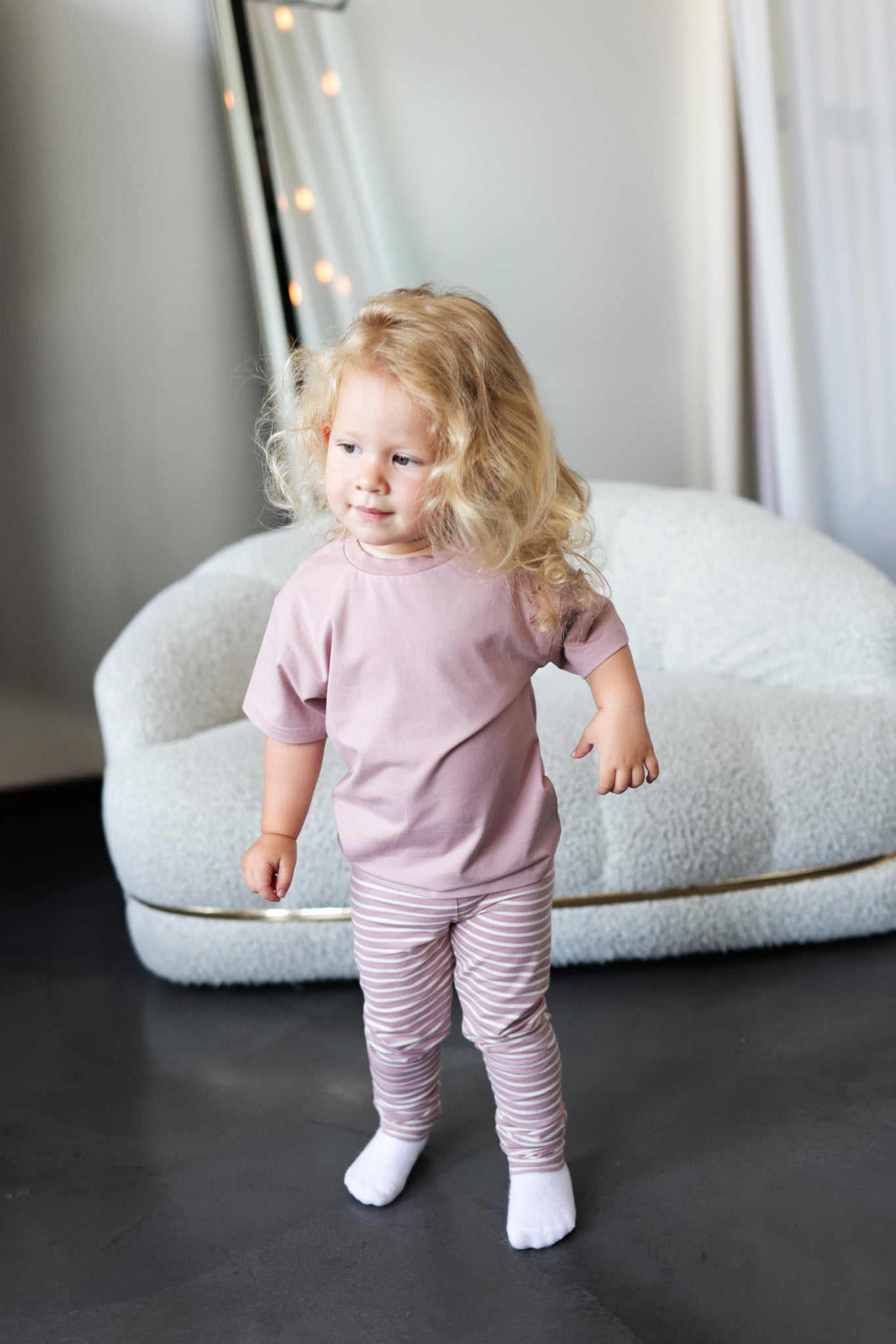 Kid playing in mauve organic cotton tee by KidORCA
