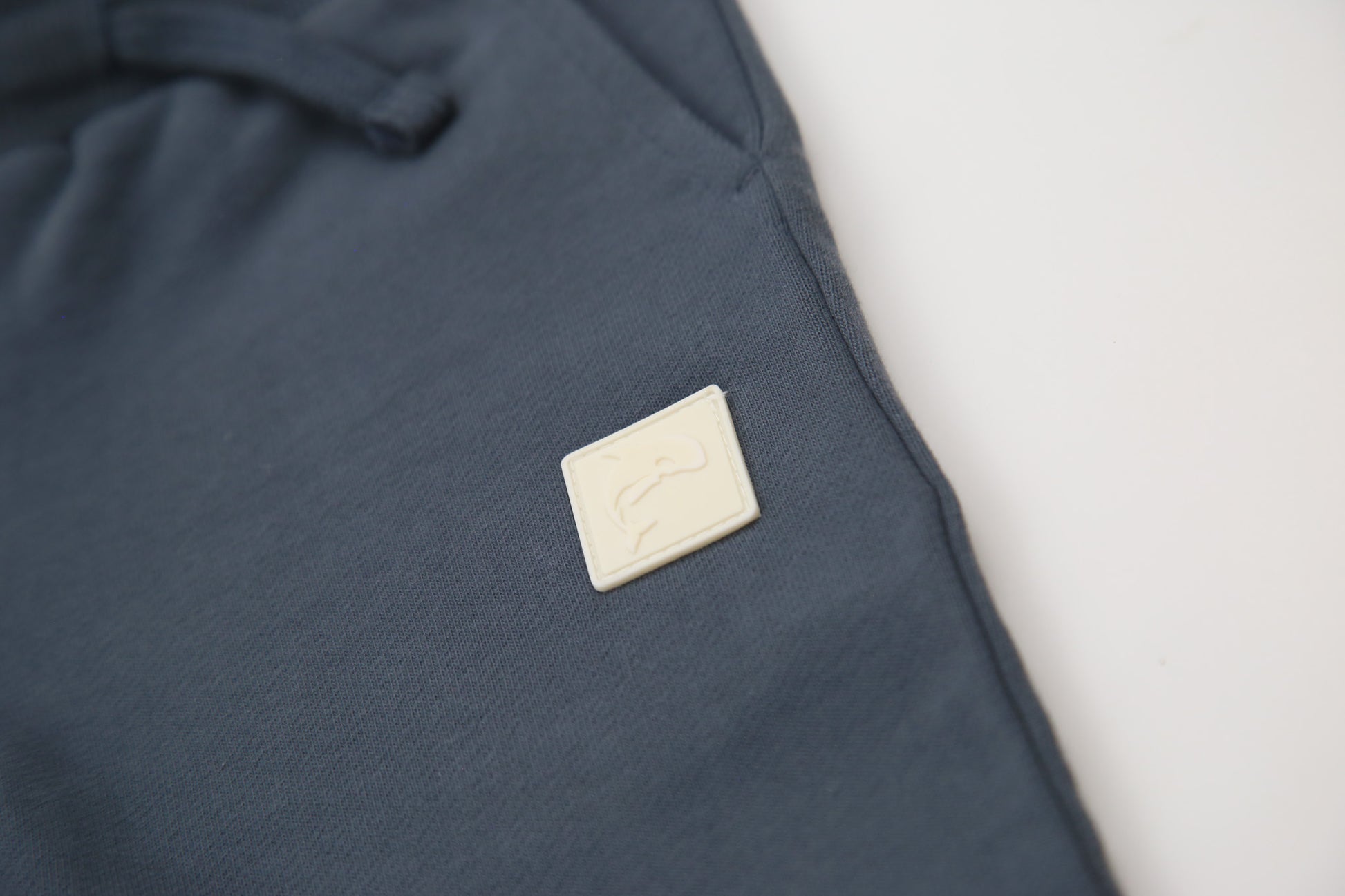 Close-up of organic french terry fabric texture – fjord blue kids sweatpants