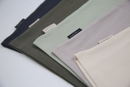 Close-up of organic cotton fabric texture – oat beige kids tee