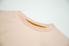 Crew neckline and seam detail on pale rose organic cotton tee