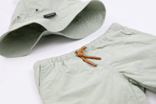 Close-up of quick-dry recycled polyester fabric – sage green swim trunks