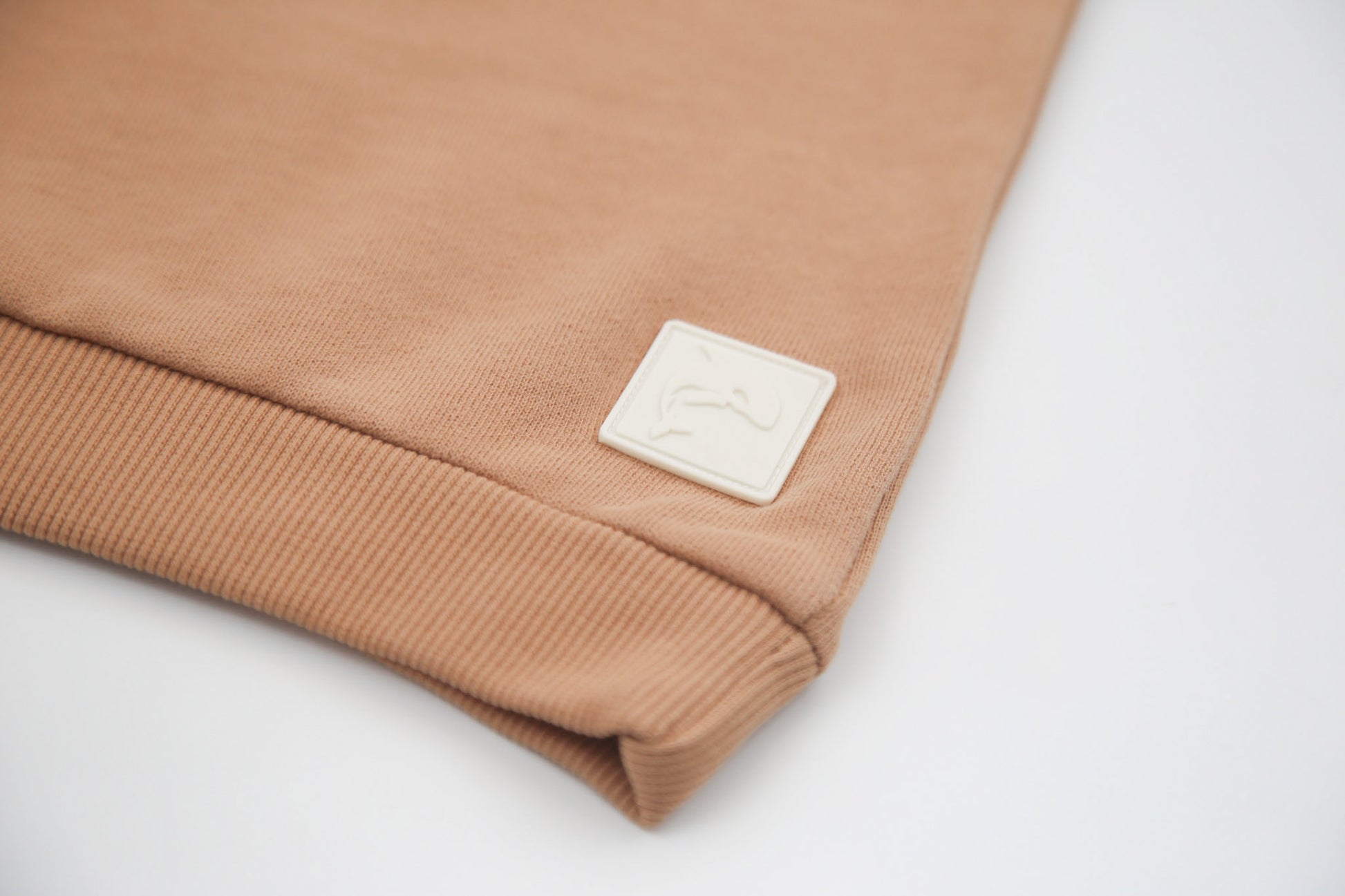 Rib cuff and hem detail on sandstone french terry kids sweatshirt