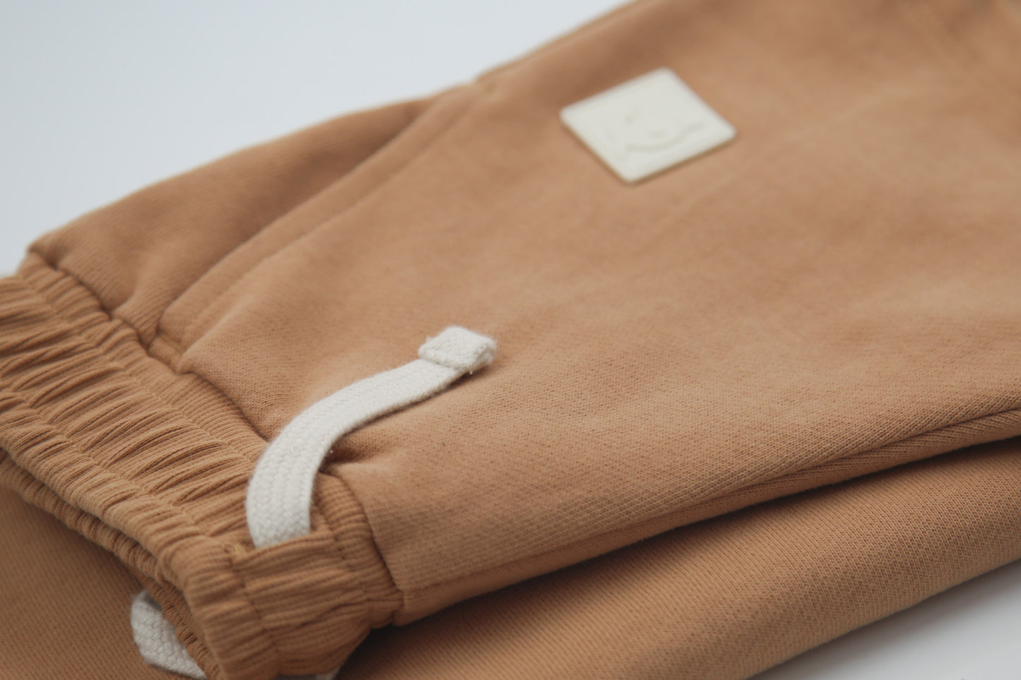 Close-up of organic french terry fabric texture – sandstone kids shorts