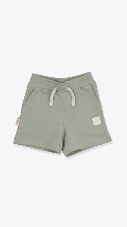 Organic french terry kids shorts in sage green – front view