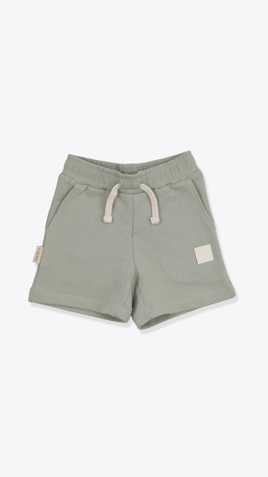 Organic french terry kids shorts in sage green – front view