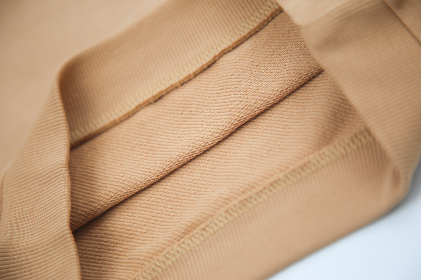 Close-up of soft organic french terry fabric texture – sandstone kids shorts