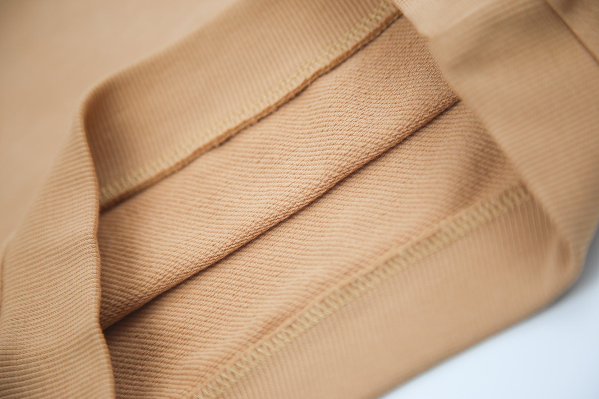 Close-up of soft organic french terry fabric texture – sandstone kids shorts