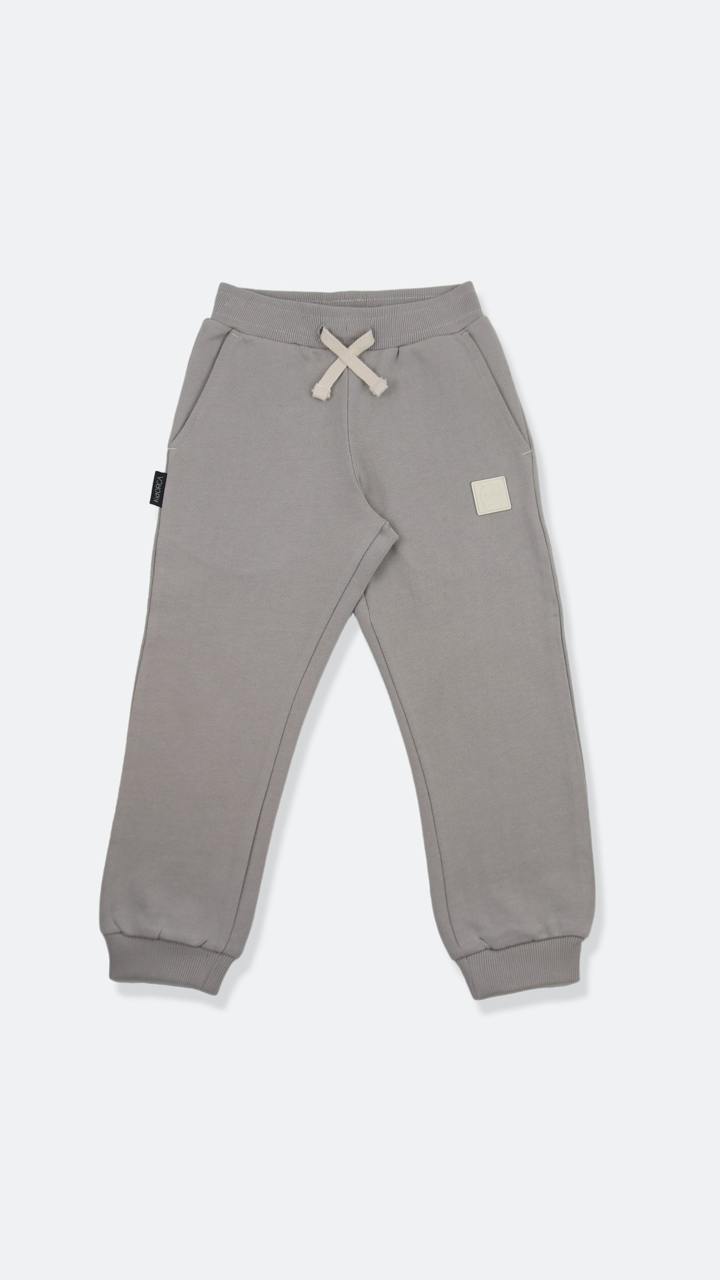 Organic french terry kids sweatpants in pebble grey – front view