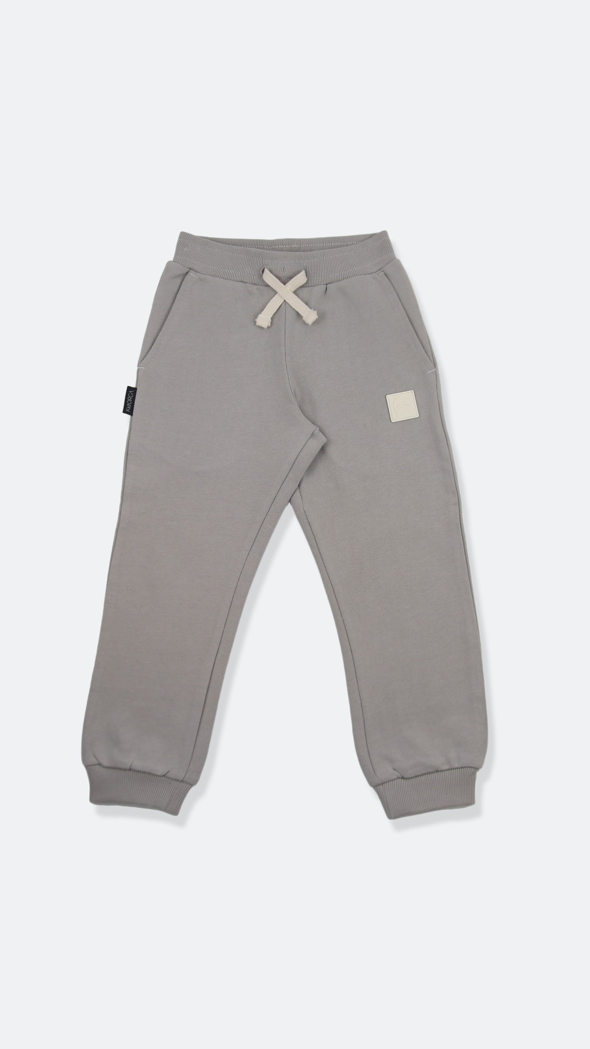 Organic french terry kids sweatpants in pebble grey – front view