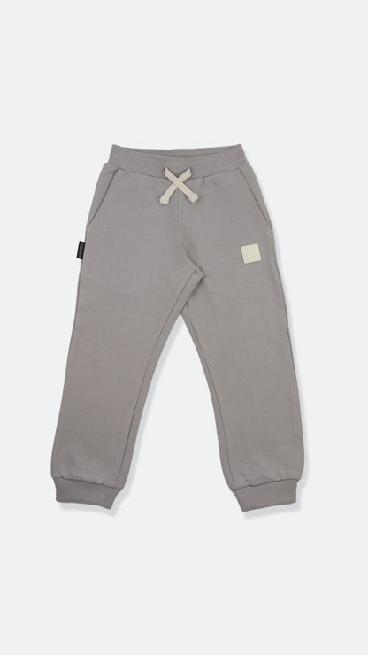 Organic french terry kids sweatpants in pebble grey – front view