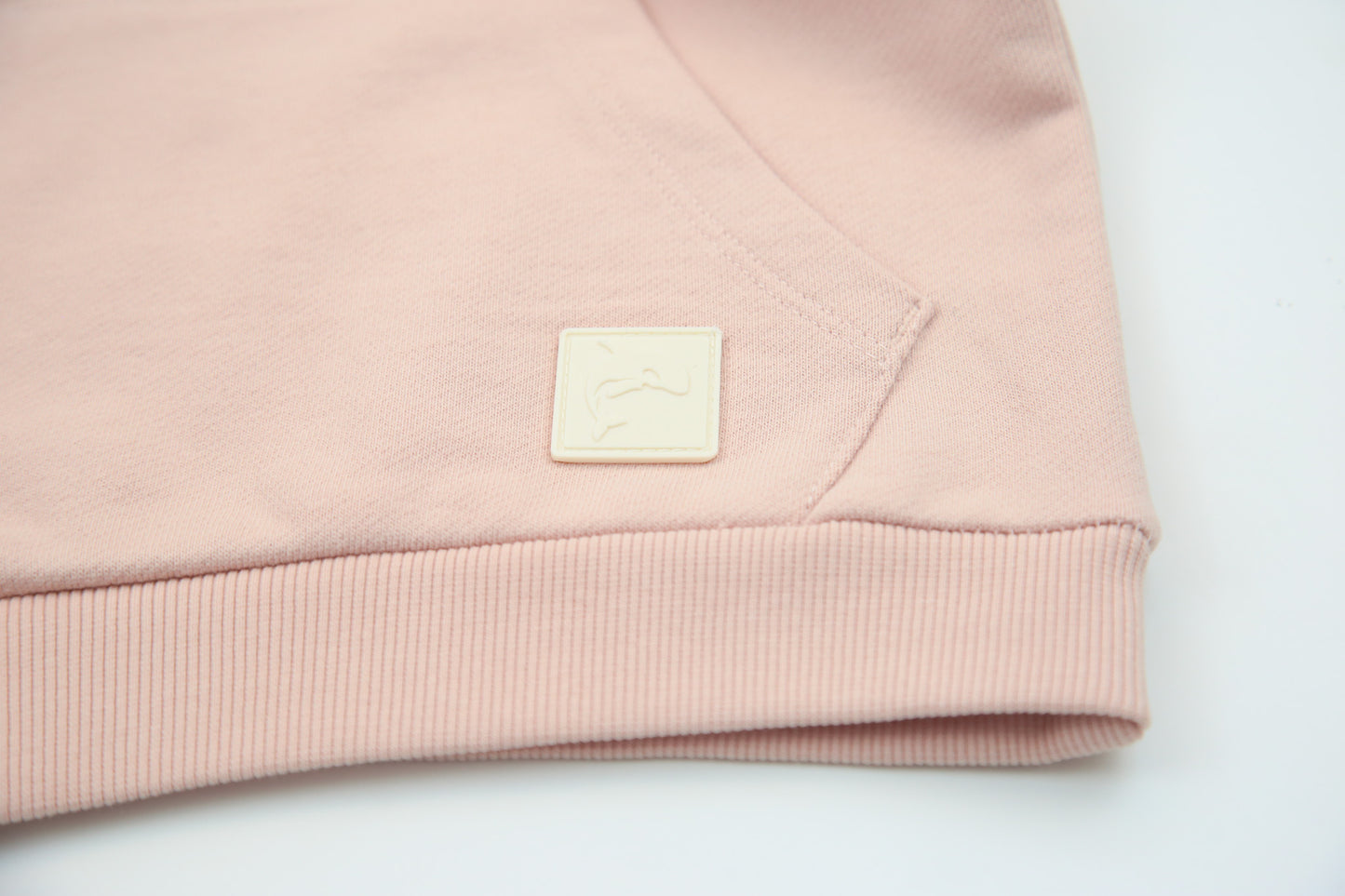 Kangaroo pocket and rib cuff detail on pale rose french terry kids hoodie