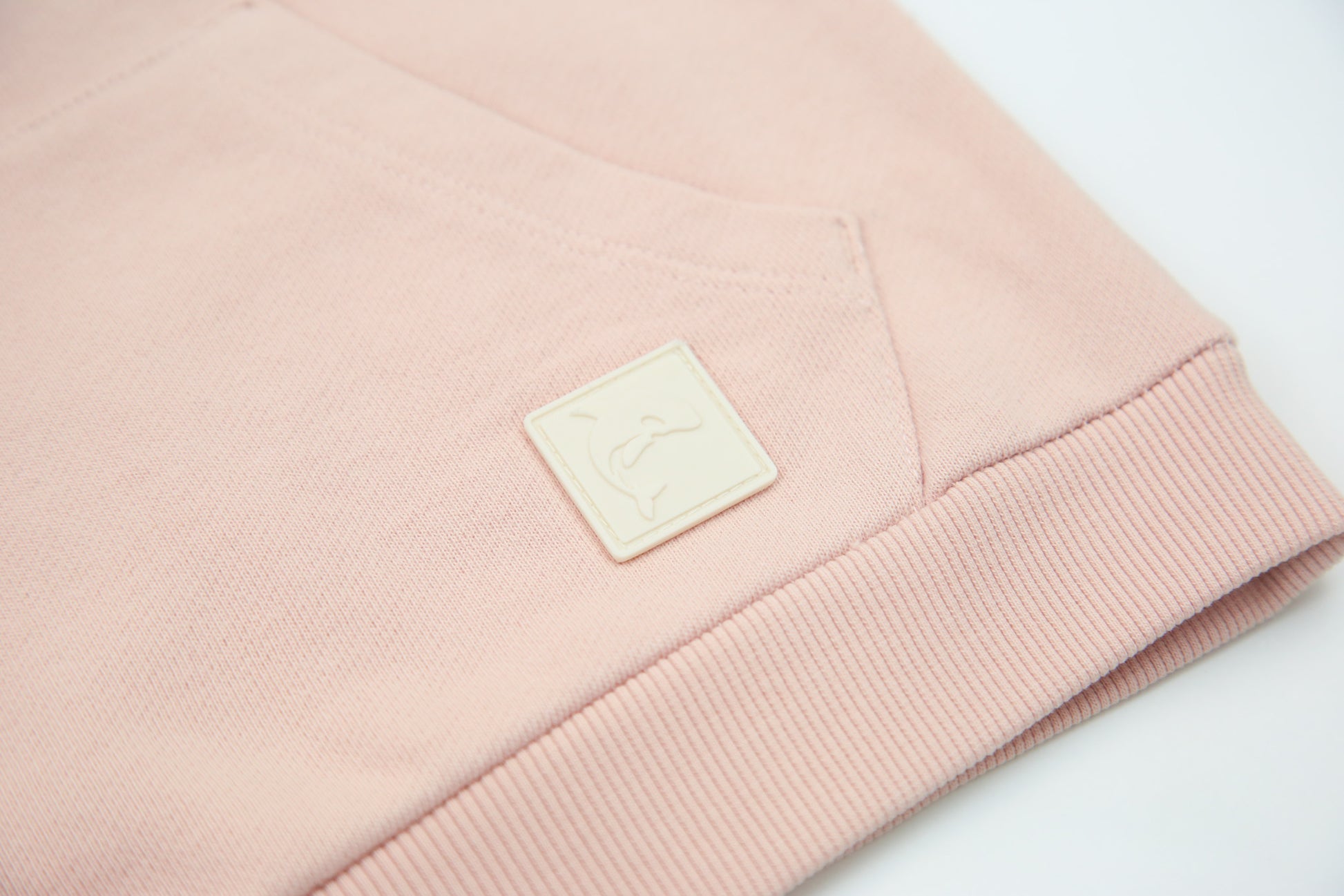 Kangaroo pocket and rib cuff detail on pale rose french terry kids hoodie