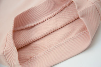 Close-up of soft organic french terry fabric texture – pale rose hoodie