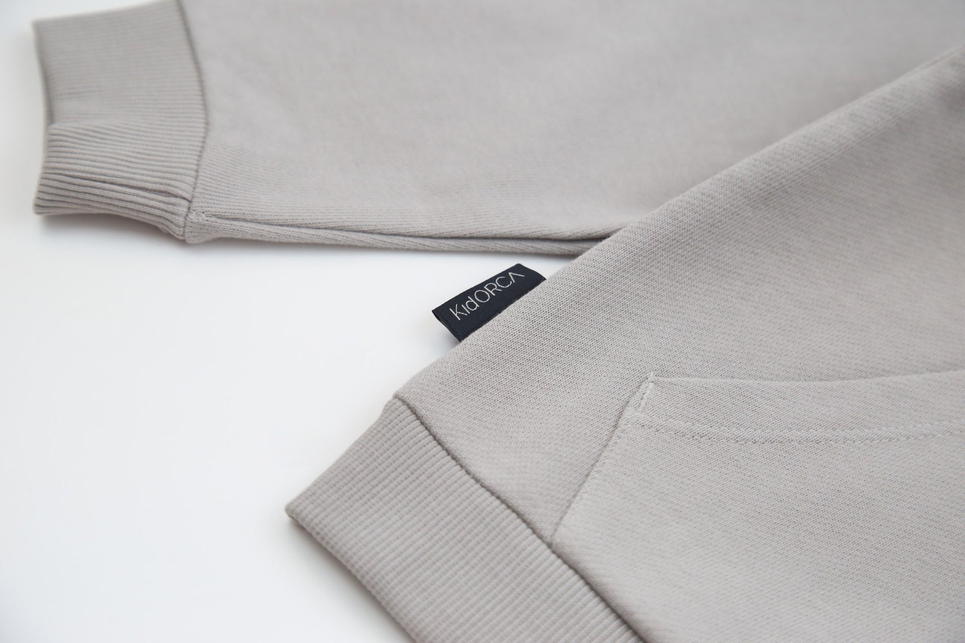 Kangaroo pocket and rib cuff detail on pebble french terry kids hoodie