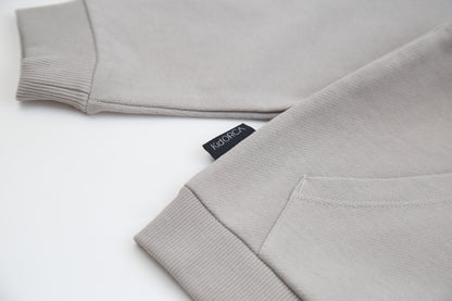 Kangaroo pocket and rib cuff detail on pebble french terry kids hoodie