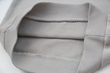 Close-up of soft organic french terry fabric texture – pebble grey kids hoodie