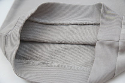 Close-up of soft organic french terry fabric texture – pebble grey kids hoodie