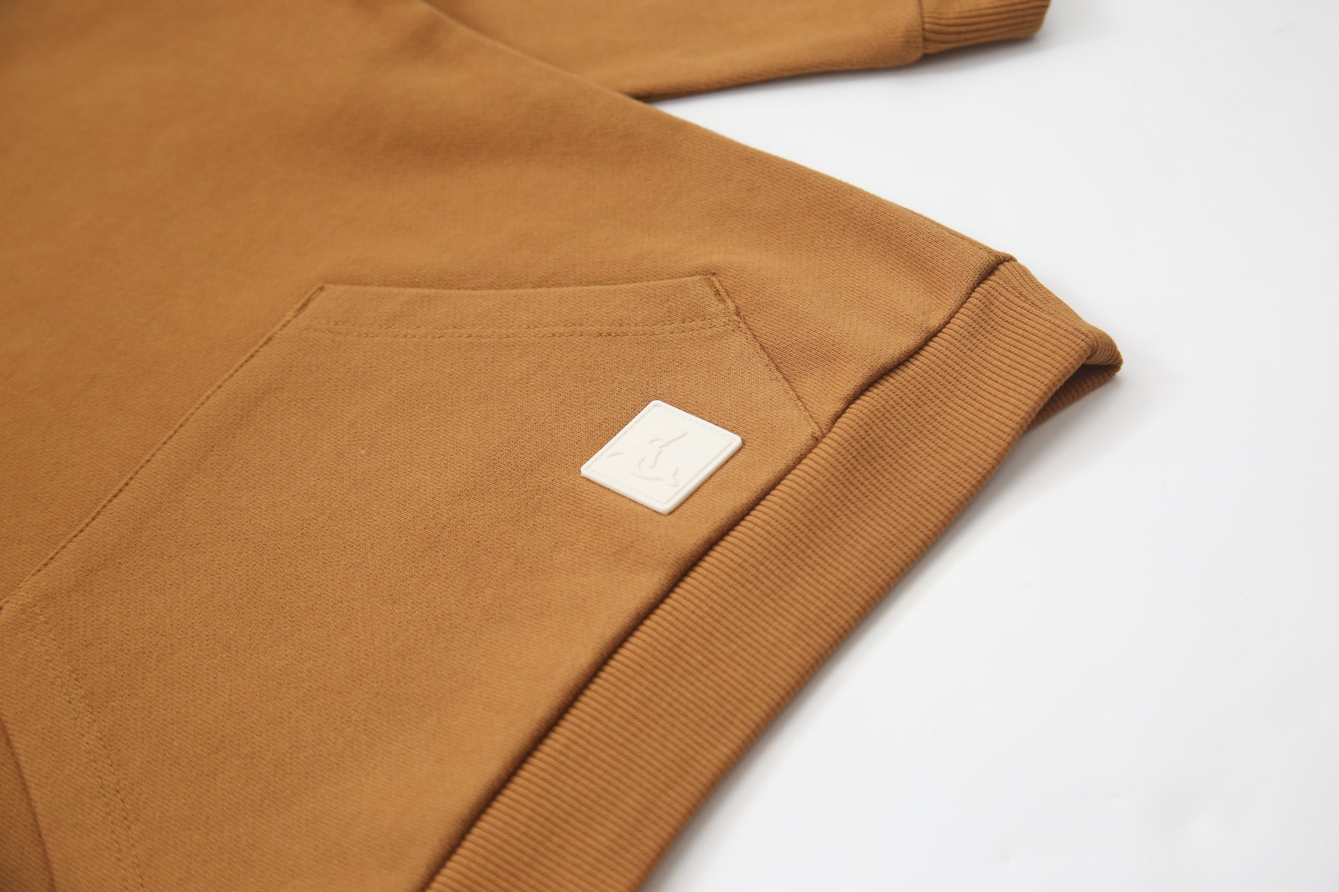 Kangaroo pocket and rib cuff detail on ginger french terry kids hoodie
