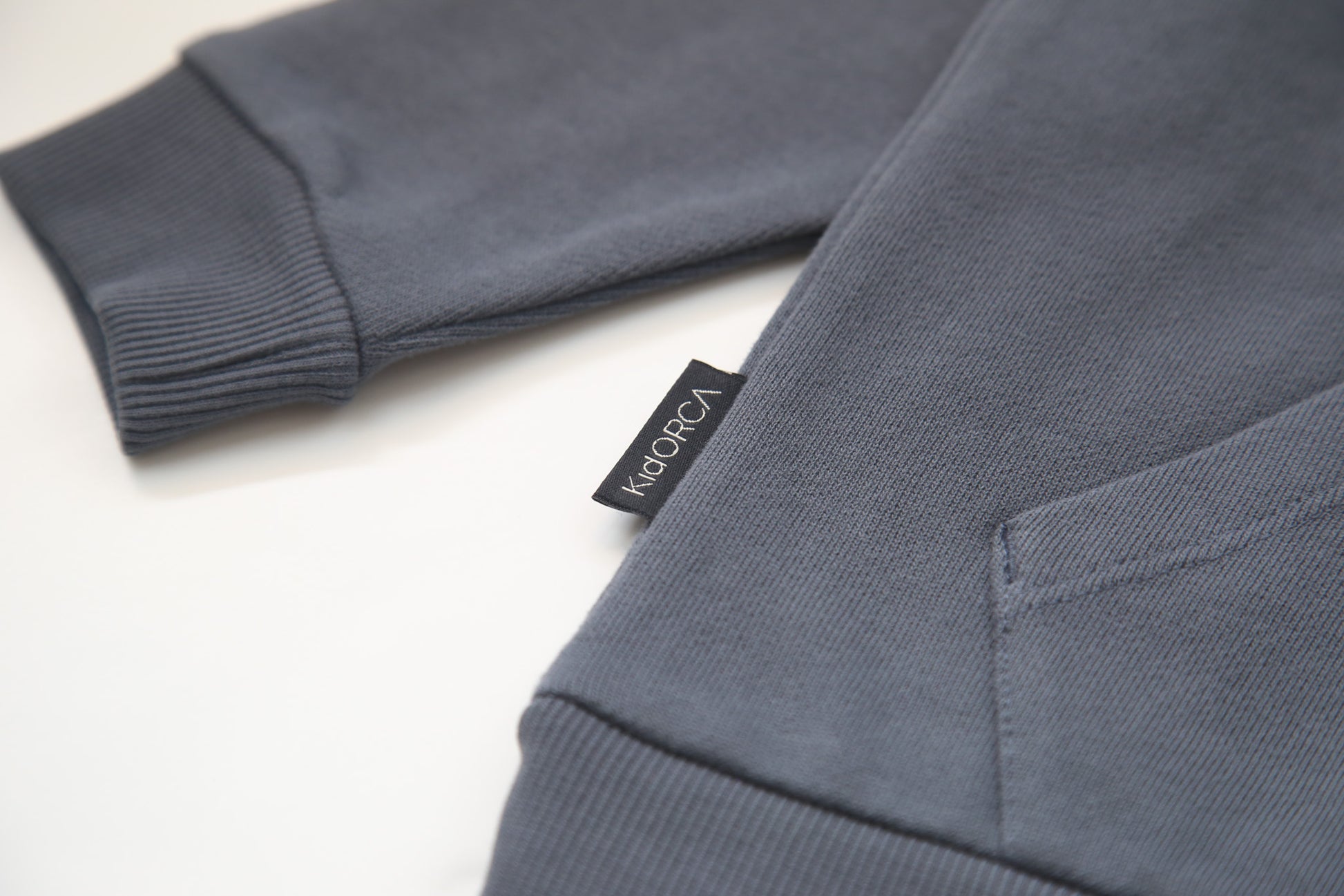 Kangaroo pocket and rib cuff detail on fjord french terry kids hoodie